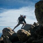 photo of man climbing mountain